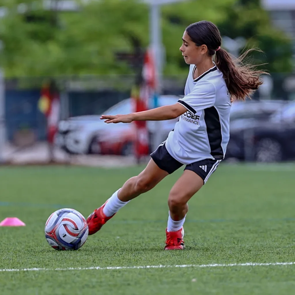Young player about to strike the ball during training