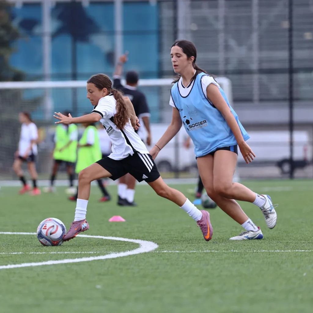 Two players competing for the ball during a drill
