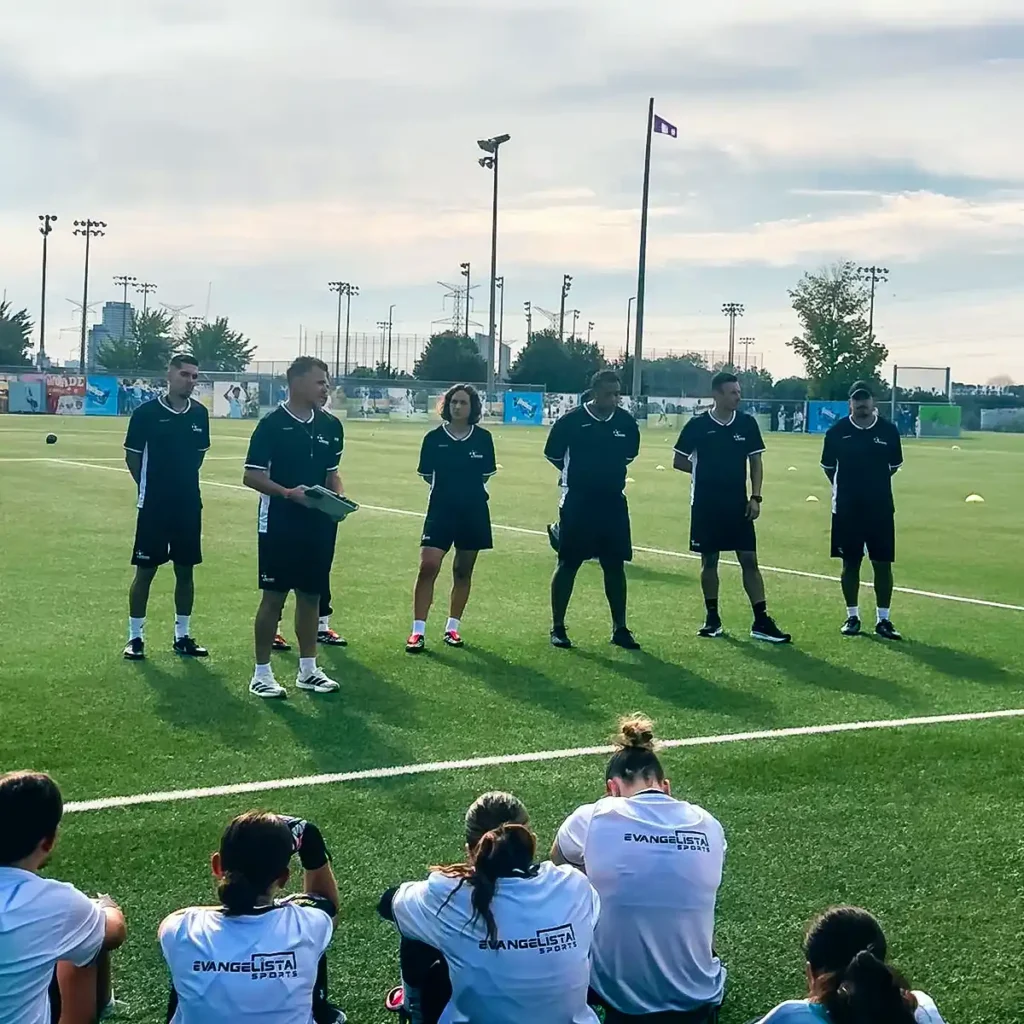 Coaching staff addressing players during the camp